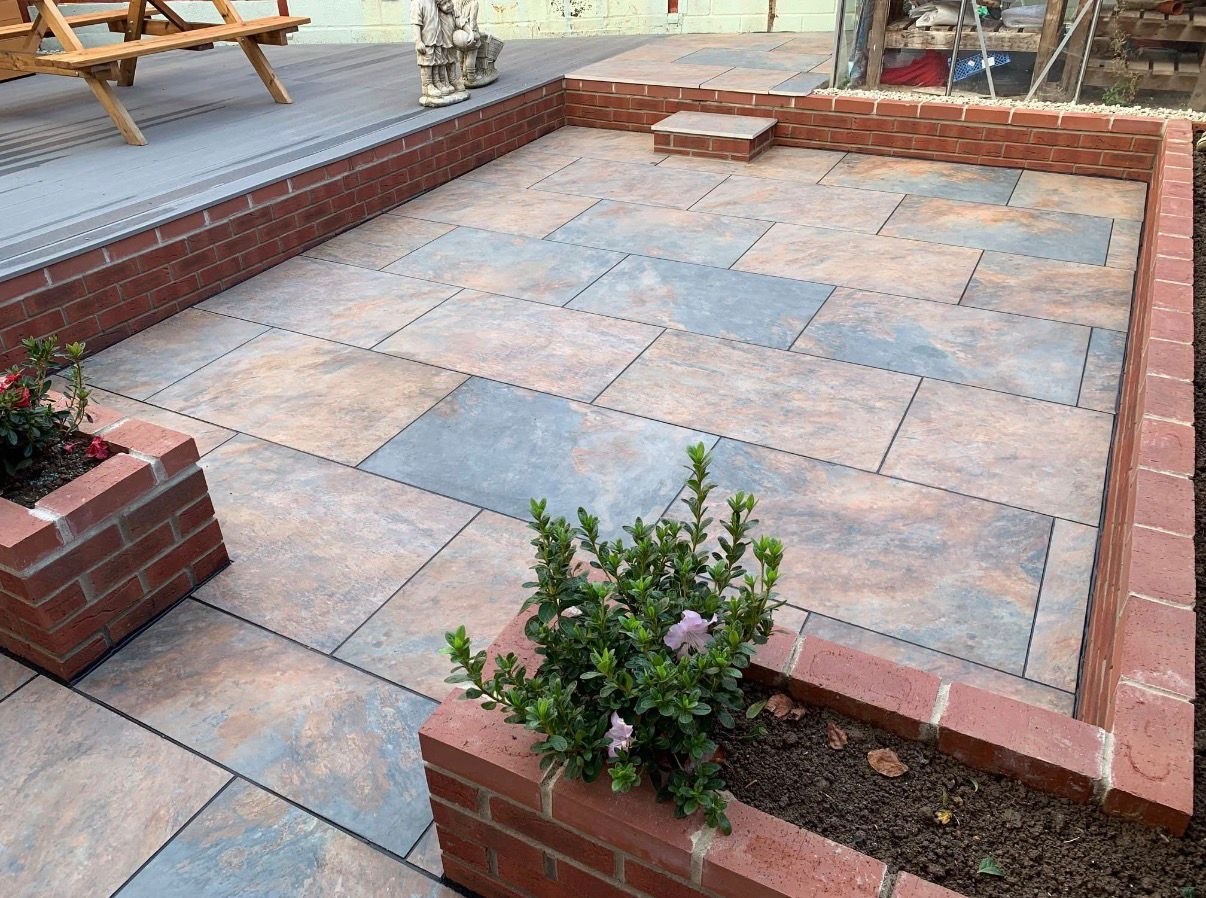 Sandstone patio with brick borders